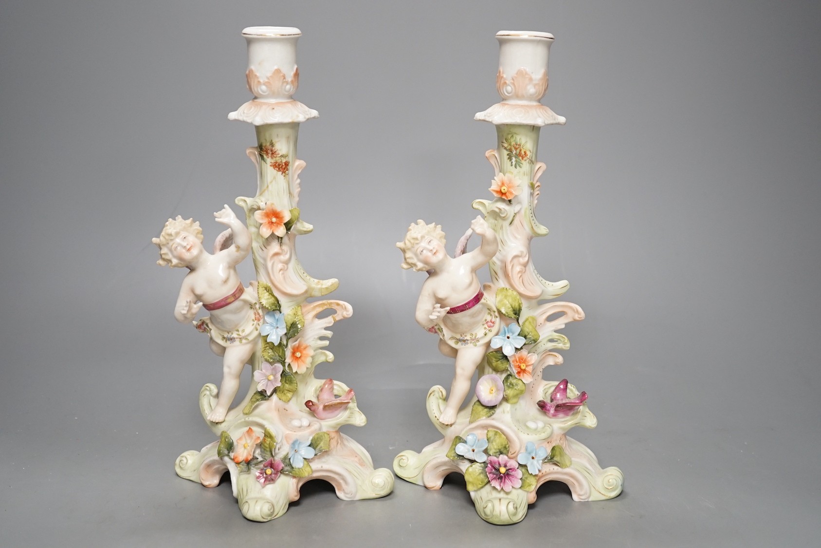 A Meissen flower painted pierced dish and two German porcelain candlesticks - 25.5cm tall